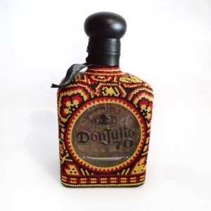 Don Julio 790 Huichol Edition with Tequileros: Luxury tequila and ancestral art in gold, crimson and black.